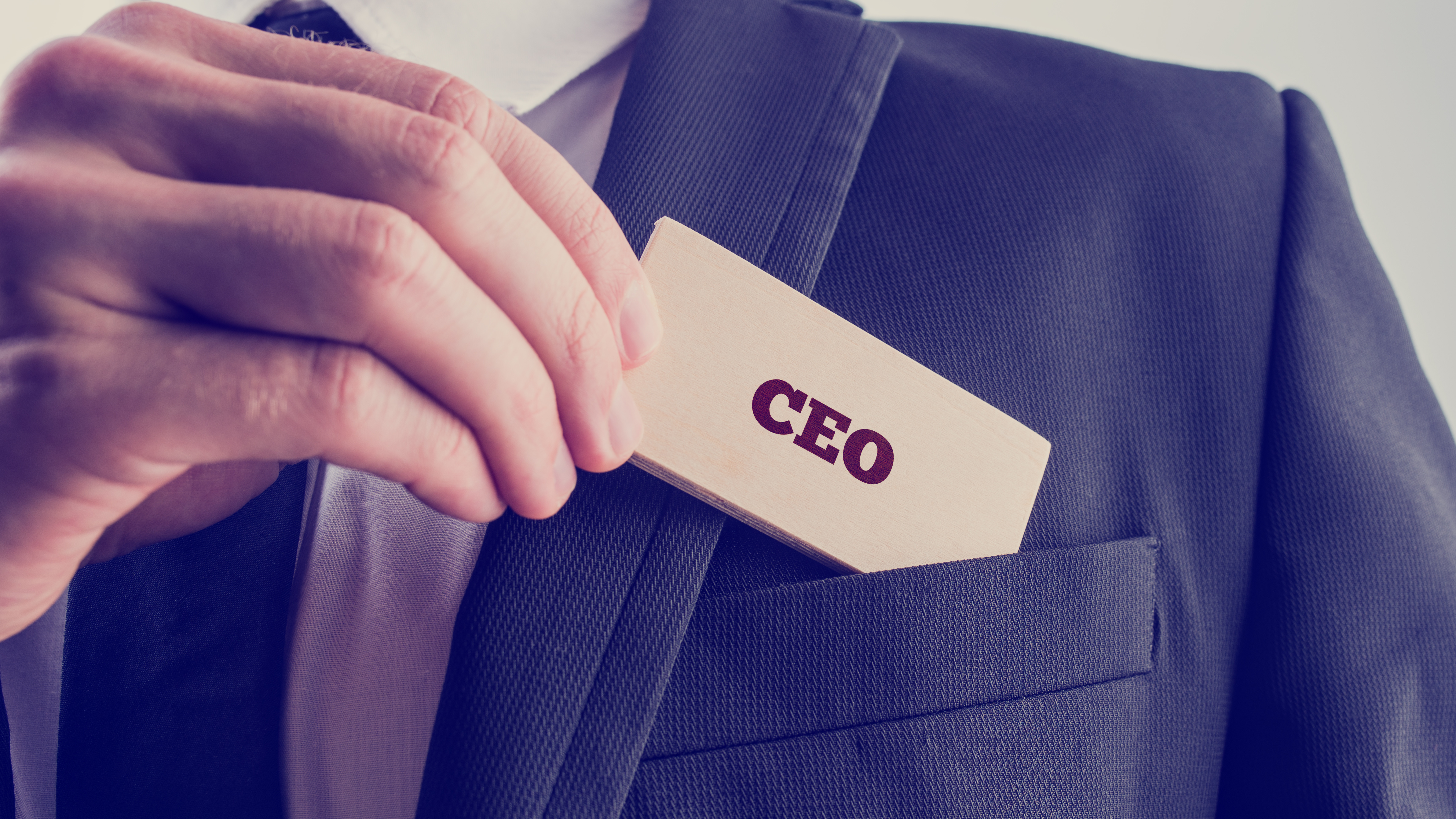 Businessman showing a card reading CEO