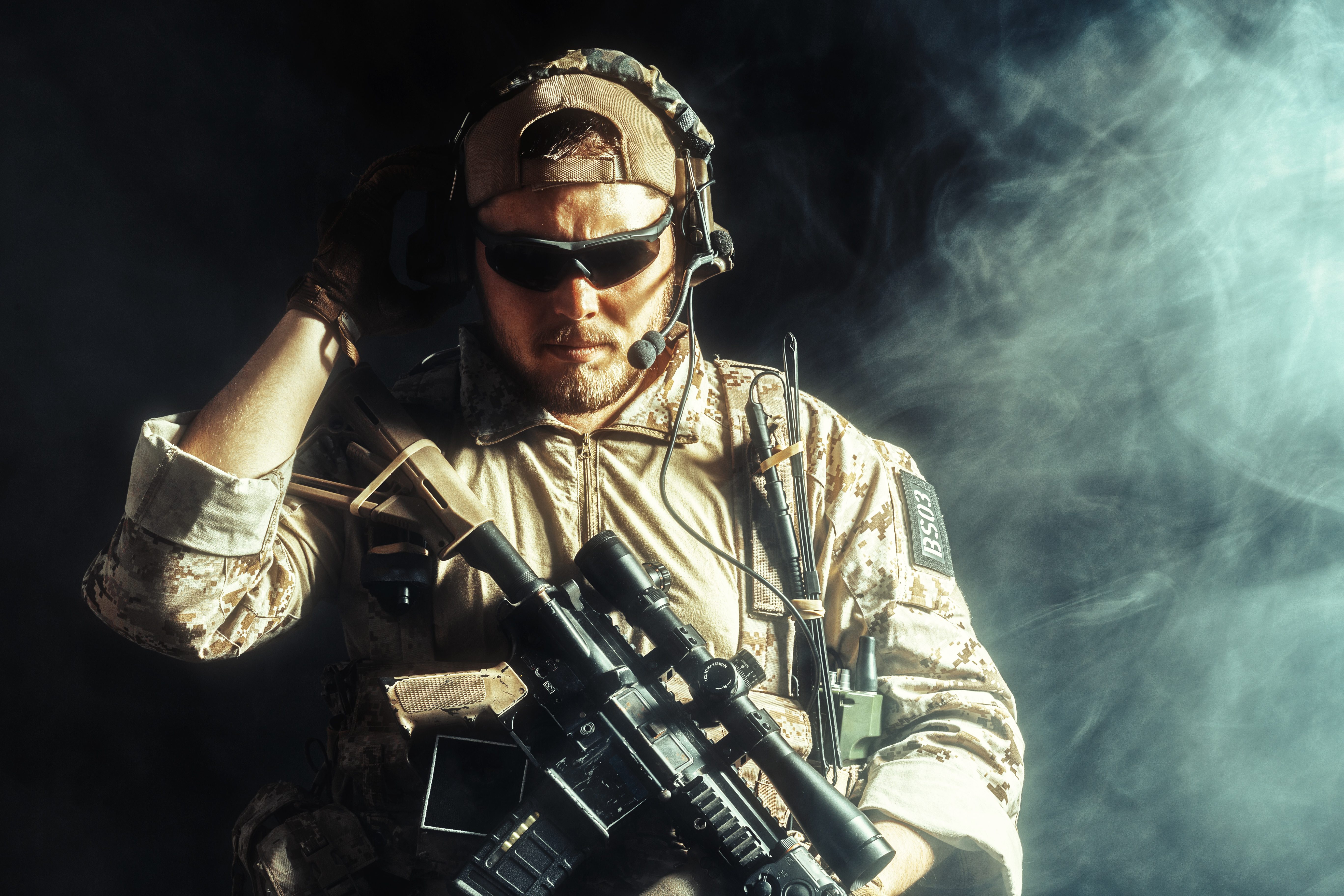 Special forces soldier with rifle on dark background